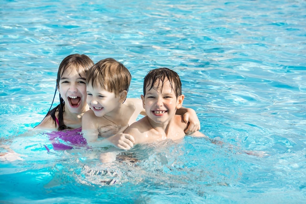 Young kids having fun in warm pool
