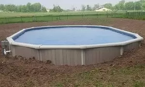 An above ground pool in the center of a field built by Splashworks Pool and Spa.