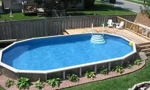 A top view of an above ground pool built in the backyard of a house.